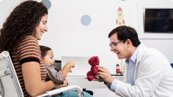 Pediatric specialist engaging with a child and caregiver
